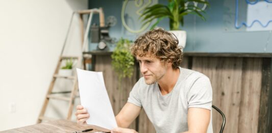 Kiedy ZUS może cofnąć rentę lub obniżyć stopień niepełnosprawności podczas komisji kontrolnej? Mężczyzna analizujący